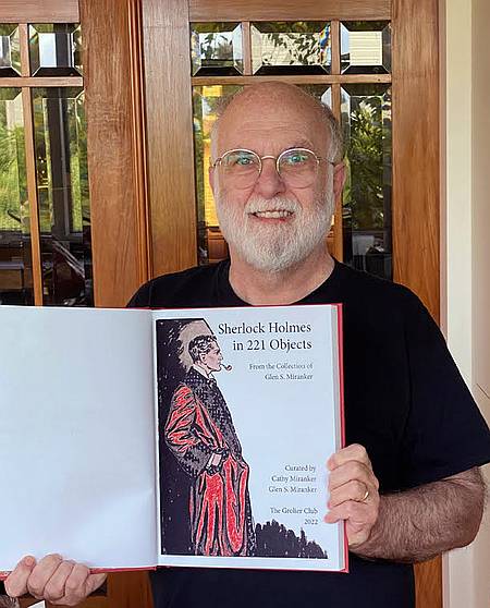 Glen Miranker holding a copy of the catalogue for Sherlock Holmes in 221 Objects